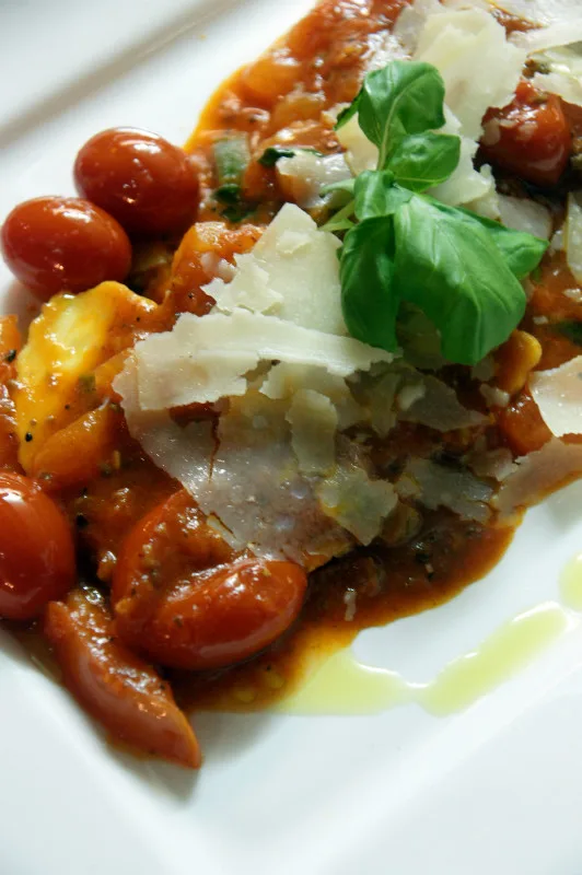 Pasta in kerstomatensaus met parmezaanschilfers, verse basilicum en olijfolie bij Da Marianna